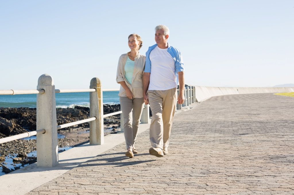 Older adults walking along a calm path at a park in Boca Raton, Florida.