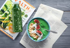 Green smoothie bowl with banana, figs, walnuts, coconut, and chia seeds illustrating brain-supportive nutrition